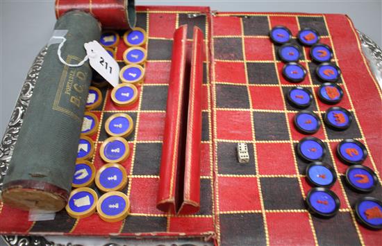 A 19th century Jaques Patent portable B.C.D. backgammon, chess and draughts board set, the gilt tooled red morocco cylinder holder